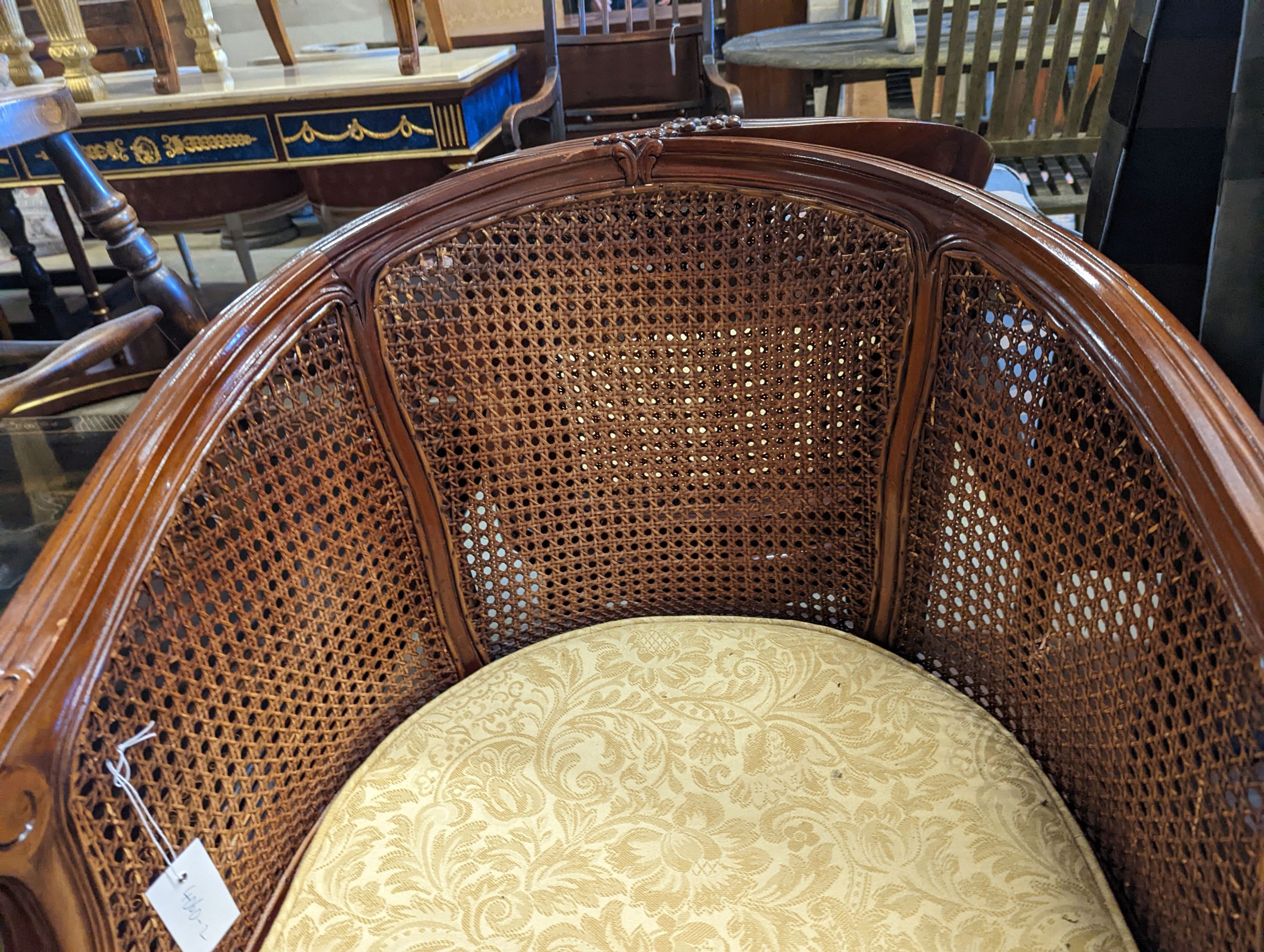 A pair of French mahogany bergere tub chairs, width 62cm, depth 50cm, height 86cm